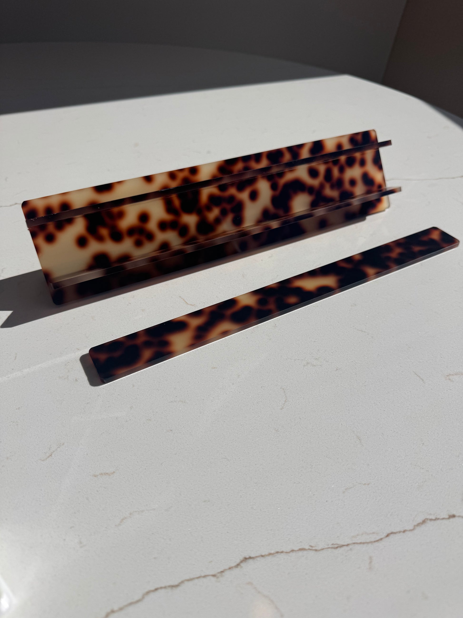Mahj Mood tortoiseshell travel mahjong racks — acrylic rack pieces on marble surface, collapsible design