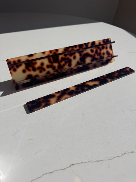 Mahj Mood tortoiseshell travel mahjong racks — acrylic rack pieces on marble surface, collapsible design