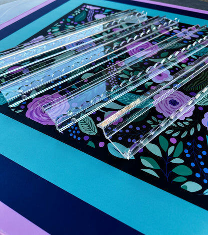 Mahj Mood scalloped clear acrylic mahjong racks styled on a dark floral Mahj Mood mat showing the set of 4 in use