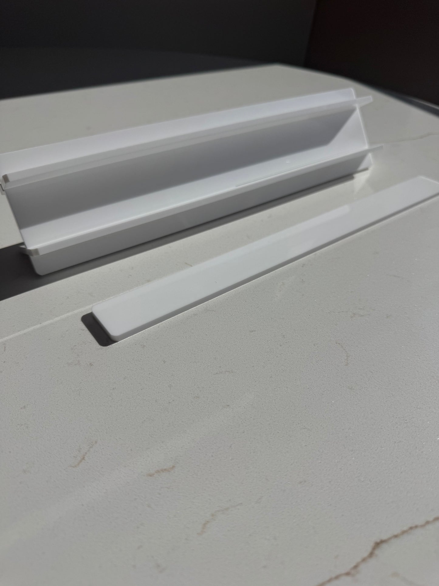 Mahj Mood white acrylic travel mahjong racks close-up — compact rack pieces stacked showing slim profile