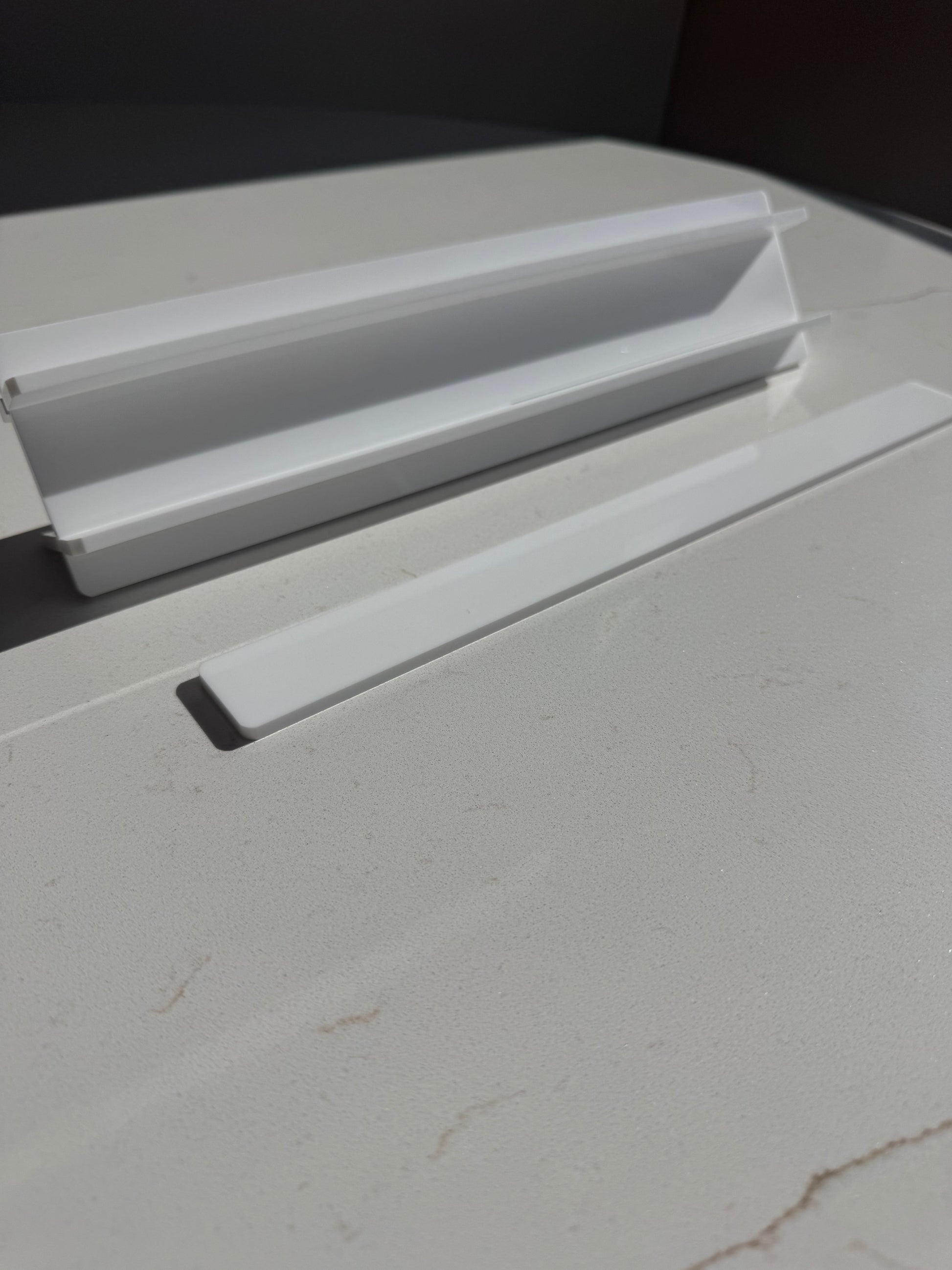 Mahj Mood white acrylic travel mahjong racks close-up — compact rack pieces stacked showing slim profile