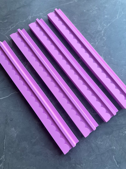Mahj Mood scalloped pink wooden mahjong rack set of 4 laid flat overhead view on a dark marble surface showing all four racks