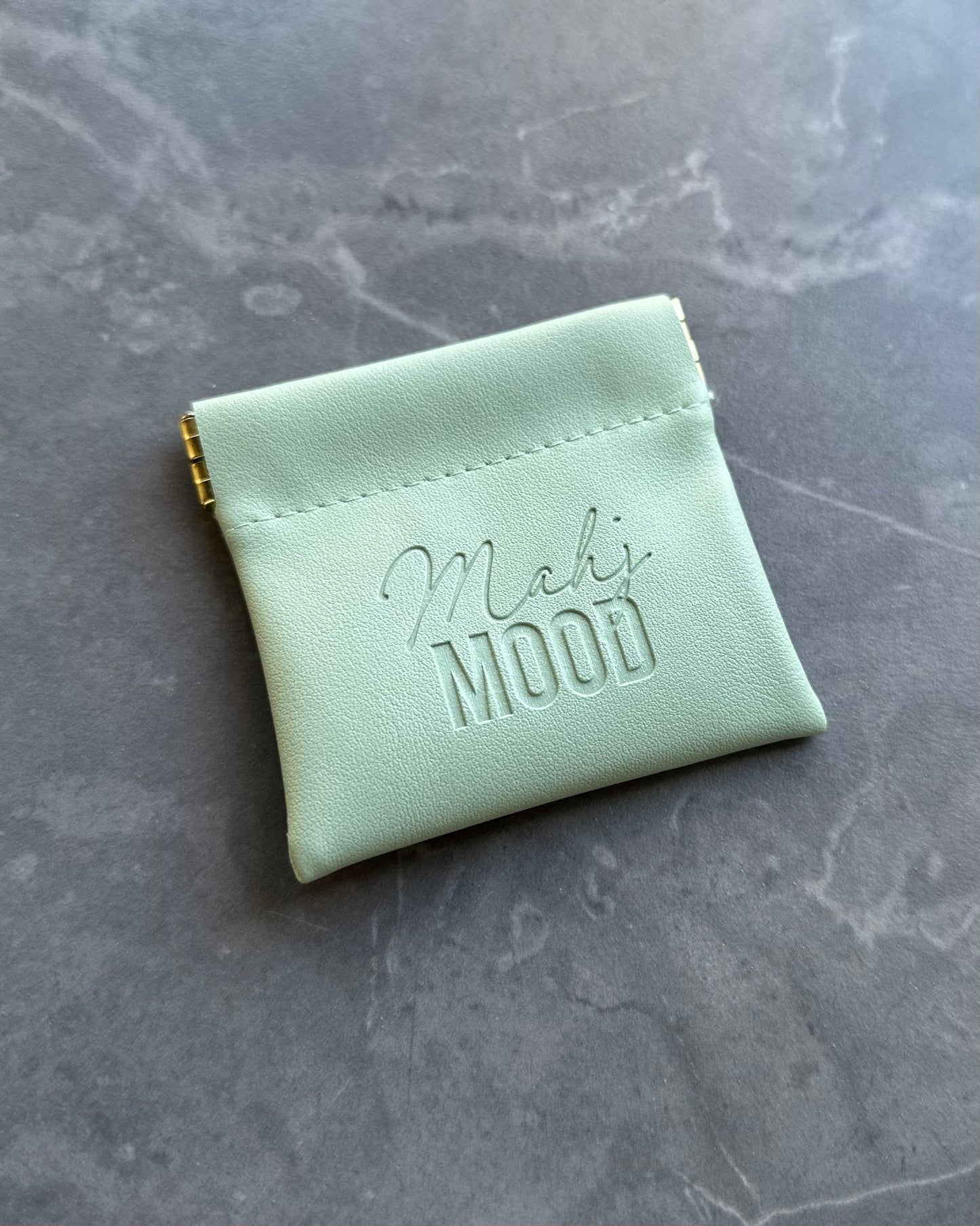 Mahj Mood magnetic dice bag in mint green faux leather with embossed logo — compact mahjong accessory pouch