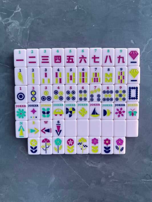 Mahj Mood Ballerina Pink full mahjong tile set laid out on a grey surface showing all suits with pink and colorful engraved designs