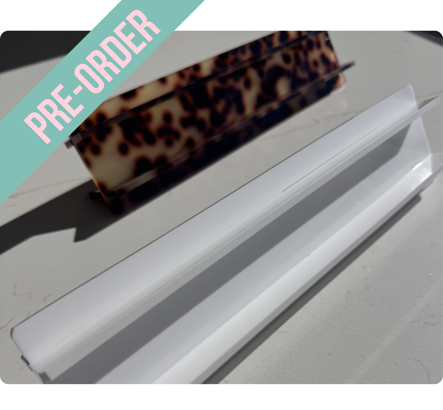 Mahj Mood travel mahjong rack comparison — tortoiseshell acrylic rack above clear white acrylic rack